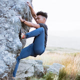 Adventurer climbing rocks wearing Trailhead mountain pants